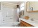 Bright bathroom featuring a shower-tub combo, a toilet, and a vanity with wooden drawers at 3917 Ashwood Ln # 57, Sarasota, FL 34232