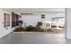 Covered carport area featuring a tiled border garden and security door at 3917 Ashwood Ln # 57, Sarasota, FL 34232
