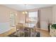 Bright dining room with a chandelier, wood floors, and a large window that brings in natural light at 3917 Ashwood Ln # 57, Sarasota, FL 34232