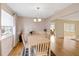 Well-lit dining room with hardwood floors and chandelier lighting fixture at 3917 Ashwood Ln # 57, Sarasota, FL 34232