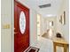 Bright entryway with white tile floors and a decorative red front door at 3917 Ashwood Ln # 57, Sarasota, FL 34232