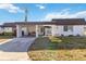 Charming single story home with a carport and well maintained front yard on a sunny day at 3917 Ashwood Ln # 57, Sarasota, FL 34232