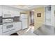 Clean kitchen with white appliances, tiled floors, and granite countertops at 3917 Ashwood Ln # 57, Sarasota, FL 34232