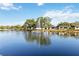 Scenic view of a pond with a fountain, surrounded by well-maintained homes and greenery at 3917 Ashwood Ln # 57, Sarasota, FL 34232