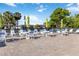 Community pool area with tables, chairs, umbrellas, and sun loungers on a sunny day at 3917 Ashwood Ln # 57, Sarasota, FL 34232
