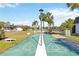 Community shuffleboard court, offering a recreational amenity with palm trees in background at 3917 Ashwood Ln # 57, Sarasota, FL 34232