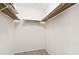 Spacious walk-in closet features neutral walls and ample shelving for optimal storage solutions at 3917 Ashwood Ln # 57, Sarasota, FL 34232
