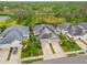 Aerial view of a two-car garage home with a green lawn and landscaping in a quiet community at 4021 Wildgrass Pl, Parrish, FL 34219