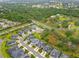 Aerial view of a neighborhood with single Gathering homes, ponds, mature trees and green spaces at 4021 Wildgrass Pl, Parrish, FL 34219