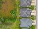 An aerial shot features a well-maintained home with lush landscaping, set in a tidy, green neighborhood at 4021 Wildgrass Pl, Parrish, FL 34219