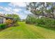 Large grassy backyard with mature trees that offers privacy and serene views at 4021 Wildgrass Pl, Parrish, FL 34219