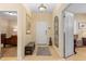 Inviting foyer with neutral tones, tile flooring, bench seating, and an elegant mirror at 4021 Wildgrass Pl, Parrish, FL 34219