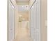 Hallway with two closets leading to a bathroom with a glass shower at 4021 Wildgrass Pl, Parrish, FL 34219