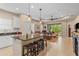 Open-concept kitchen with granite counters, stainless appliances and bar seating overlooks the living room at 4021 Wildgrass Pl, Parrish, FL 34219