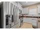 Modern kitchen featuring stainless steel appliances, granite countertops, and white cabinets at 4021 Wildgrass Pl, Parrish, FL 34219