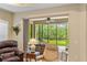 Inviting lanai with comfortable seating and lush backyard views at 4021 Wildgrass Pl, Parrish, FL 34219