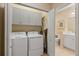 Laundry room with side-by-side washer and dryer and built-in storage space at 4021 Wildgrass Pl, Parrish, FL 34219
