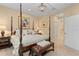 Elegantly furnished main bedroom with a view into the bathroom at 4021 Wildgrass Pl, Parrish, FL 34219