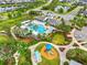 Aerial shot of community pool area with playground and community grilling area at 4021 Wildgrass Pl, Parrish, FL 34219