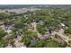 Overhead shot showing the property nestled in a lush neighborhood with mature trees and greenery at 4063 Woodview Dr, Sarasota, FL 34232