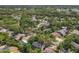 Aerial view of the community featuring mature trees, a lake, and various home styles at 4063 Woodview Dr, Sarasota, FL 34232