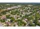 An aerial view displays the neighborhood's lush greenery, tree coverage, and well-maintained properties at 4063 Woodview Dr, Sarasota, FL 34232