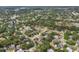 Neighborhood aerial view showcasing mature trees, landscaping, and various home styles at 4063 Woodview Dr, Sarasota, FL 34232