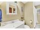Bathroom features a white vessel sink, a vanity with a mirror, and beach-themed decor at 4063 Woodview Dr, Sarasota, FL 34232