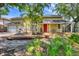 Charming two-story home with a well-maintained lawn, mature trees, front porch, and a two-car garage at 4063 Woodview Dr, Sarasota, FL 34232