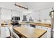 Bright kitchen with white cabinets, stainless steel appliances, and a butcher block island at 4063 Woodview Dr, Sarasota, FL 34232