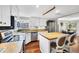 Bright kitchen with white cabinets, stainless steel appliances, and a butcher block island with seating at 4063 Woodview Dr, Sarasota, FL 34232