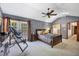 Well-lit primary bedroom featuring hardwood floors and backyard views at 4063 Woodview Dr, Sarasota, FL 34232