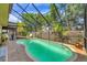 Inviting enclosed pool area with lush landscaping and comfortable patio furniture at 4063 Woodview Dr, Sarasota, FL 34232
