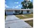 Single-story home with a wide driveway and a well-maintained lawn at 4070 Grobe St, North Port, FL 34287