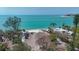 Aerial view of lush landscaping with turquoise water and waterfront property at 4214 Higel Ave, Sarasota, FL 34242
