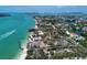 Stunning aerial view of waterfront land, gorgeous blue water, and lush surroundings at 4214 Higel Ave, Sarasota, FL 34242