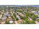 Scenic aerial view of the neighborhood showcasing a mix of residential properties with mature trees and pond at 4311 2Nd E Ave, Bradenton, FL 34208