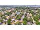 Scenic aerial view of a residential neighborhood with lush green trees and a tranquil pond at 4311 2Nd E Ave, Bradenton, FL 34208