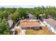 Aerial view of a cozy home surrounded by a white fence, with a well-maintained yard and mature trees at 4311 2Nd E Ave, Bradenton, FL 34208