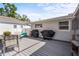 Back deck area with table, chairs and grills, ideal for outdoor entertainment and relaxation at 4311 2Nd E Ave, Bradenton, FL 34208