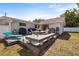 Outdoor deck with seating area, grill, and lounge chair, ideal for outdoor dining and entertaining at 4311 2Nd E Ave, Bradenton, FL 34208