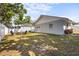 Beautifully landscaped backyard with a deck, seating area, and lush green lawn, ideal for outdoor enjoyment at 4311 2Nd E Ave, Bradenton, FL 34208