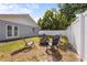 Backyard with a charming fire pit area, perfect for outdoor gatherings and relaxing under the trees at 4311 2Nd E Ave, Bradenton, FL 34208