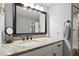 This bathroom features a large framed mirror, granite countertops and a shower/tub combo at 4311 2Nd E Ave, Bradenton, FL 34208