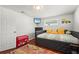 This bedroom features a daybed, a toy box, and a view from the windows at 4311 2Nd E Ave, Bradenton, FL 34208