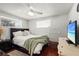 This bedroom features a bed with a dark frame and plenty of natural light at 4311 2Nd E Ave, Bradenton, FL 34208
