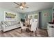 Dining area featuring a round table, cozy seating, and artwork, bathed in natural light at 4311 2Nd E Ave, Bradenton, FL 34208