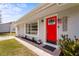 Bright red front door and brick path of this charming home enhance the curb appeal and invite a warm welcome at 4311 2Nd E Ave, Bradenton, FL 34208