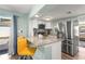 Bright kitchen featuring granite counters, stainless steel appliances, and a convenient breakfast bar with yellow seating at 4311 2Nd E Ave, Bradenton, FL 34208