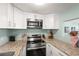 Well-equipped kitchen with stainless steel appliances, granite counters, and ample cabinet storage offers a functional cooking space at 4311 2Nd E Ave, Bradenton, FL 34208